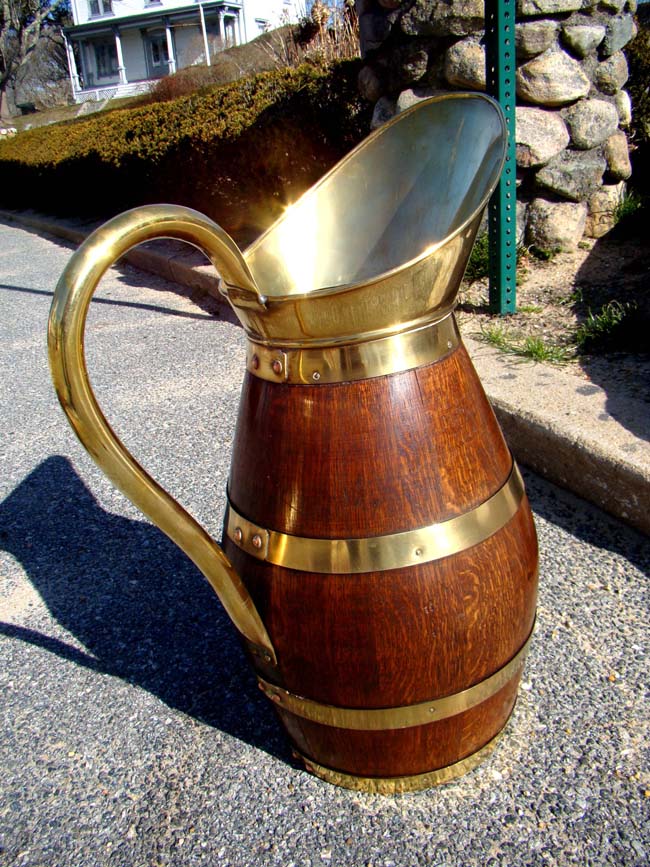 A beautiful late 19th century brass mounted oak jug